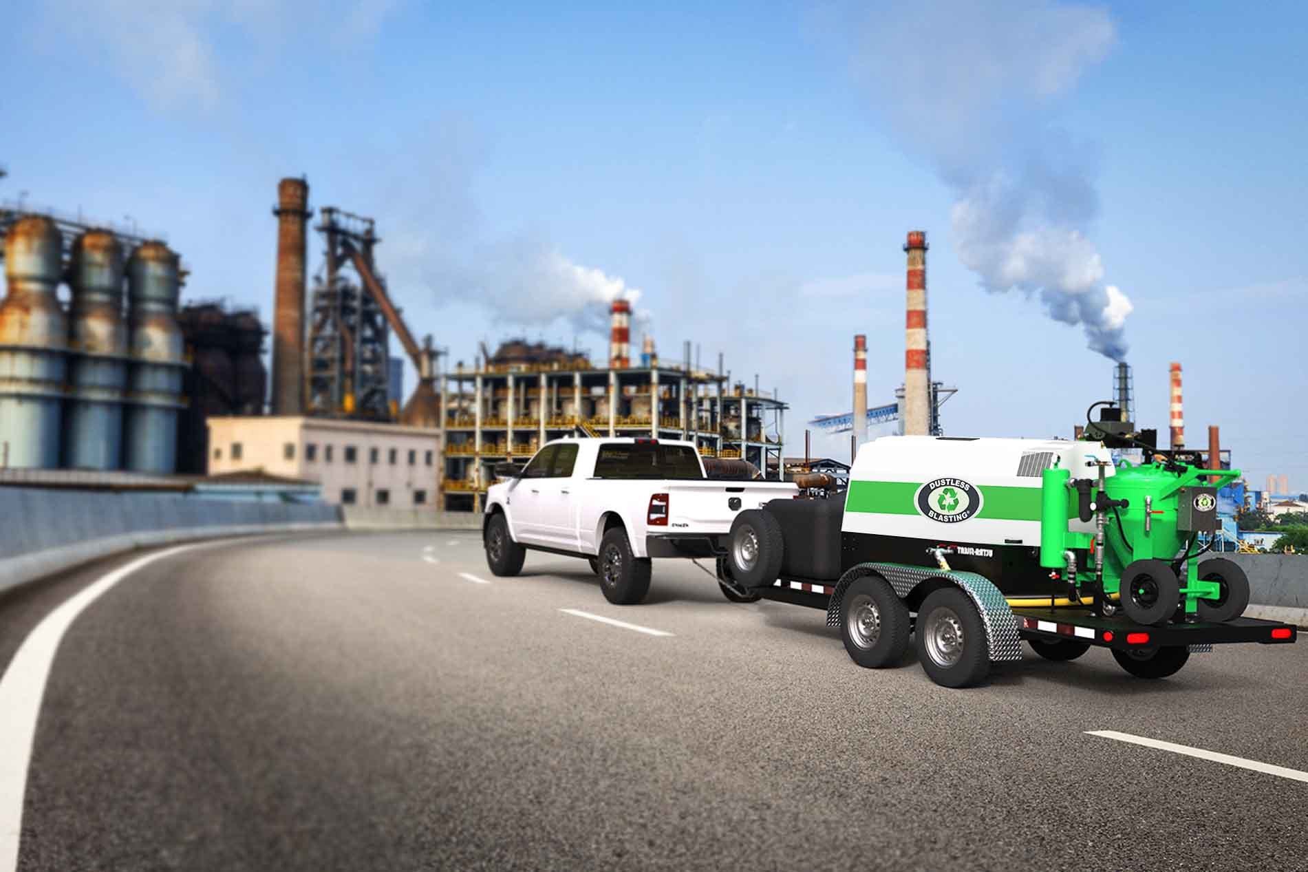 Dustless Blasting's DB500 Mobile S sandblasting trailer attached to a truck in a factory.