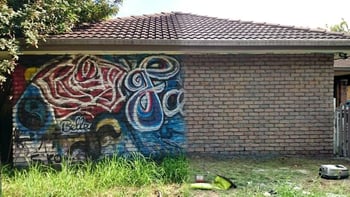 graffiti cleaned off of brick home