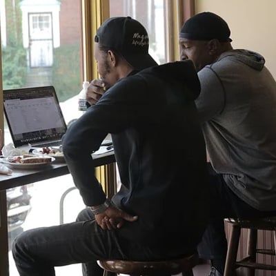 two men looking at laptop