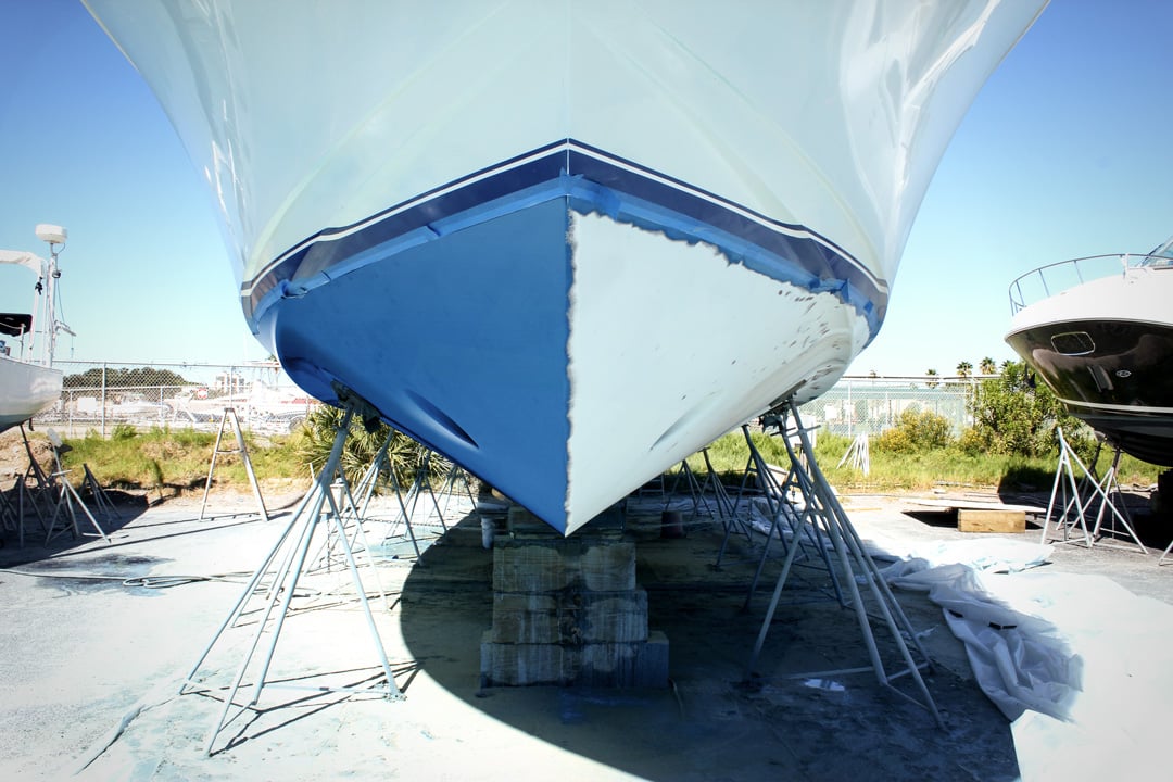 blue paint half removed from a boat bottom