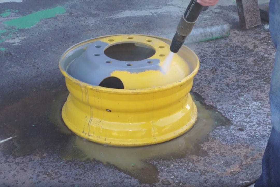 sandblasting a yellow powder coated wheel