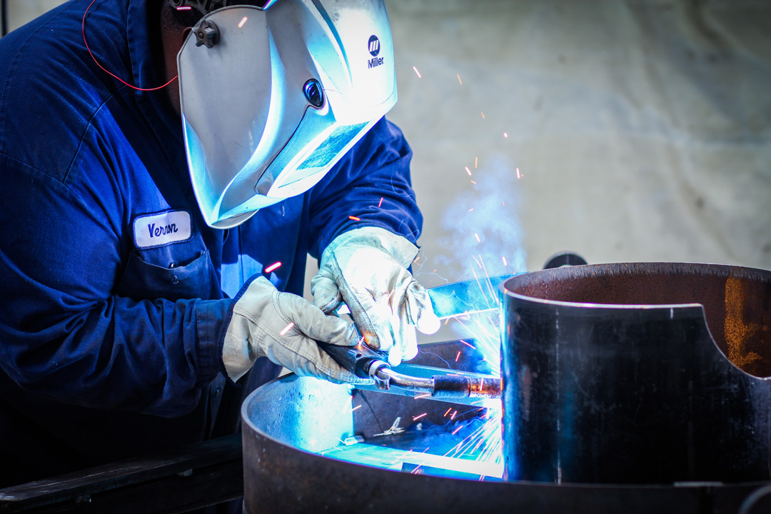 welder manufacturing an abrasive blast pot